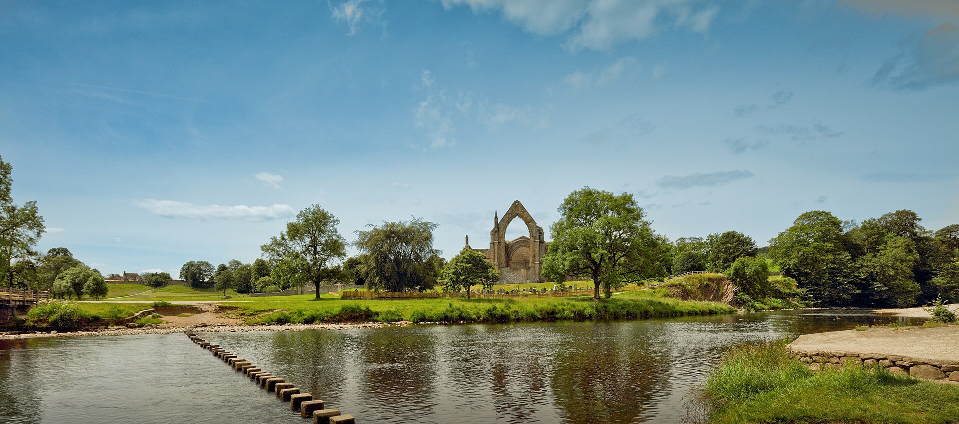 The priory ruins and stepping stones across the River Wharfe